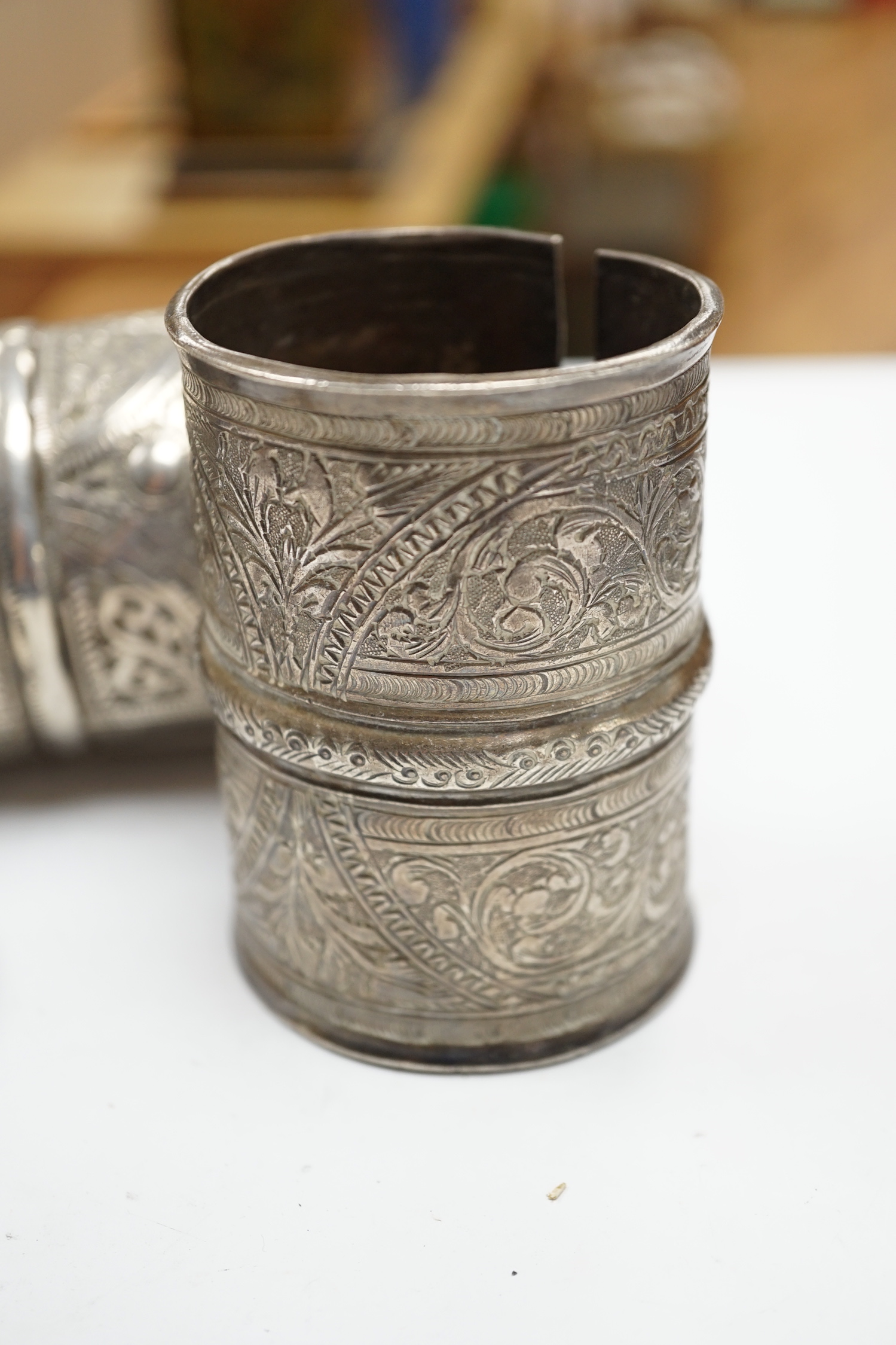 A collection of eight North African Berber white metal jewellery, etc, including bangles, cuffs and hair ornament.